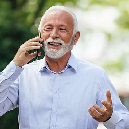 Man walking in the outdoors talking on his mobile device