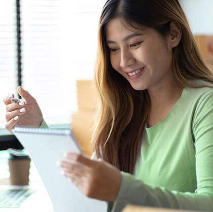 Woman uses the Astound Broadband Mover's Checklist as she prepares to move her internet services