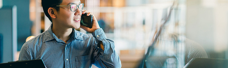 Asian man makes a cell phone call - be aware who can see your mobile data