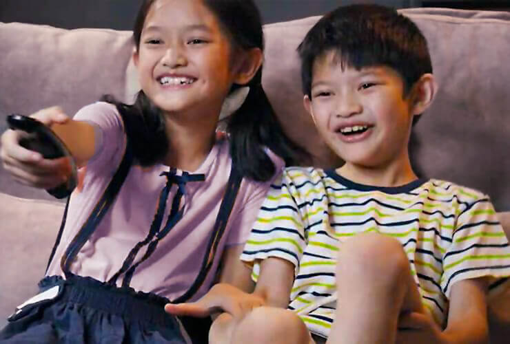 two kids laugh while streaming tv shows