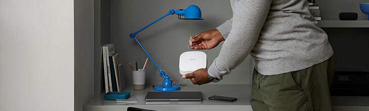 African American male plugging in a eero device