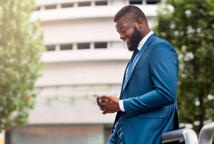 bearded African man checks his mobile data