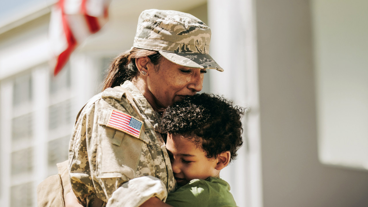 Young son hugs his military-dressed Mom on Veteran’s Day (November 11)