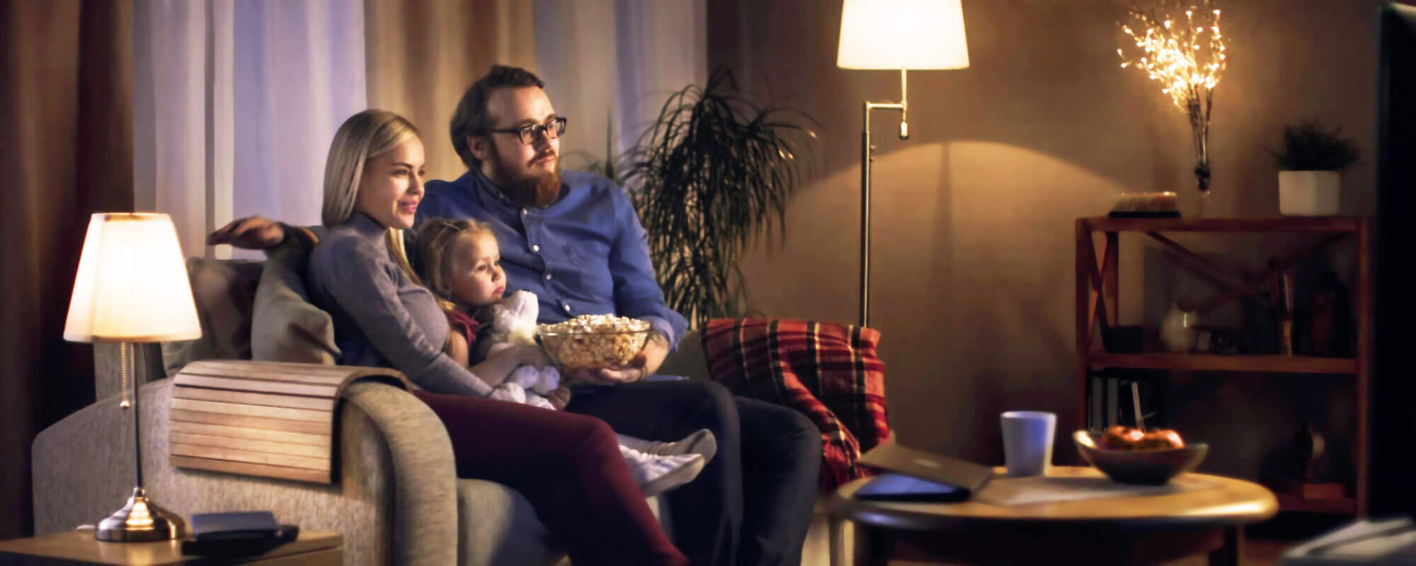 young family on the sofa watches streaming TV