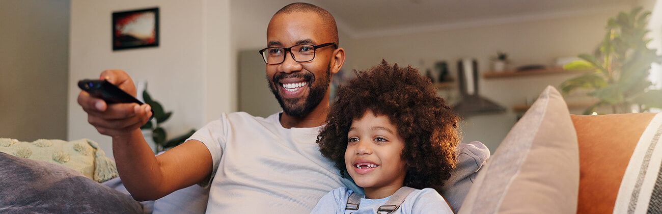 Dad and son watch shows together