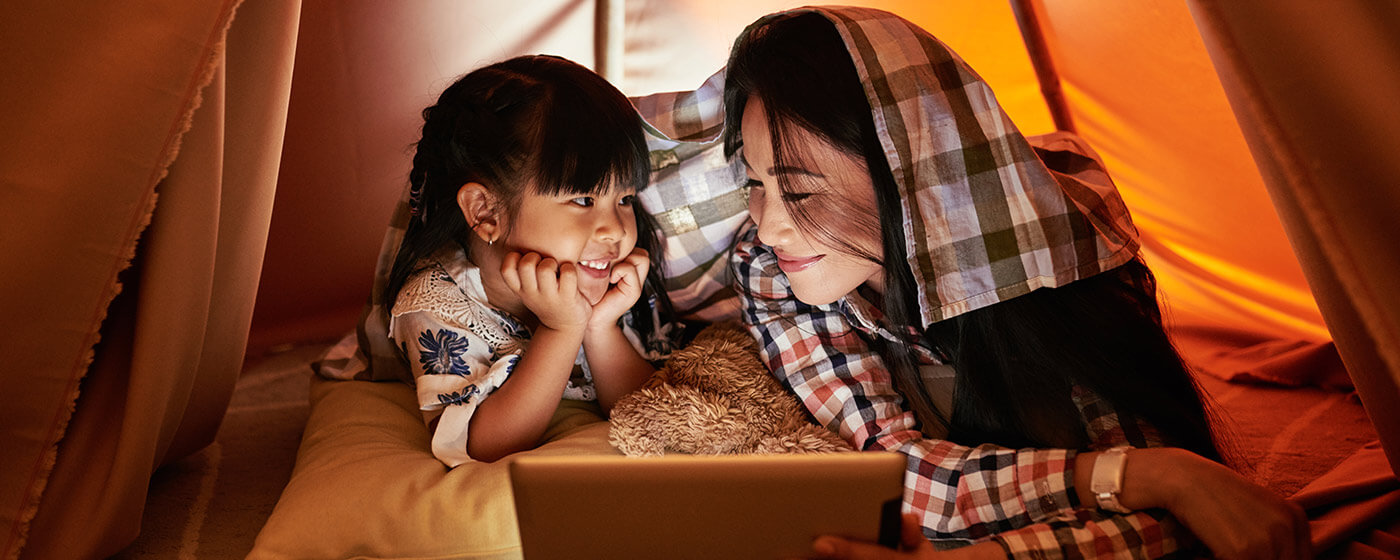 WTW Celebrate Every Day - Mom and daughter watching movies in a tent.